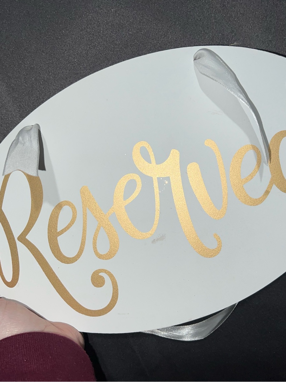 White Oval Reserved Sign with Gold Script